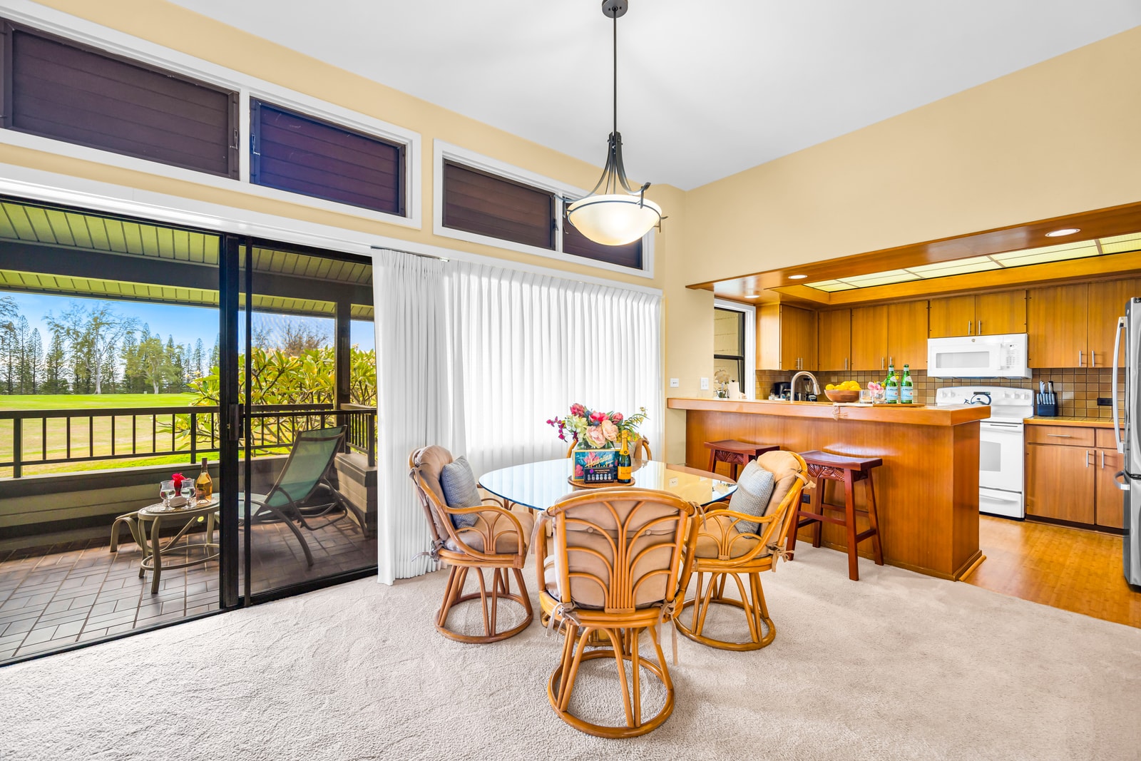 Your dining area sits just off the kitchen and lanai, with garden views and breezy natural light. KRV-2121