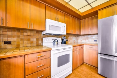 White appliances, granite counters, and classic cabinetry complete your fully equipped kitchen.