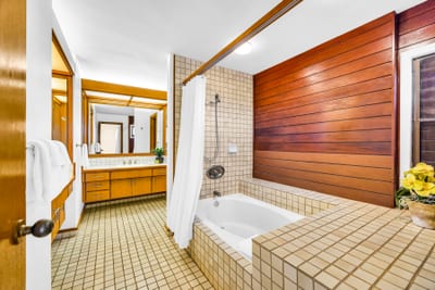 Soak in your spacious tub surrounded by natural wood for a resort-style bathroom experience.