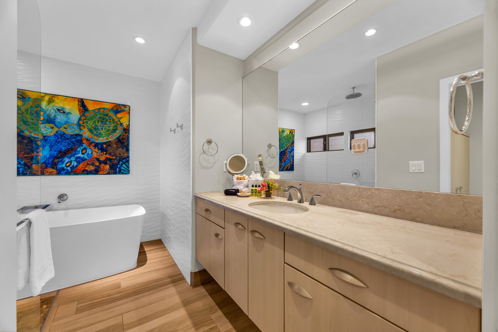Spa inspired primary bath with ample counter space and bright lighting