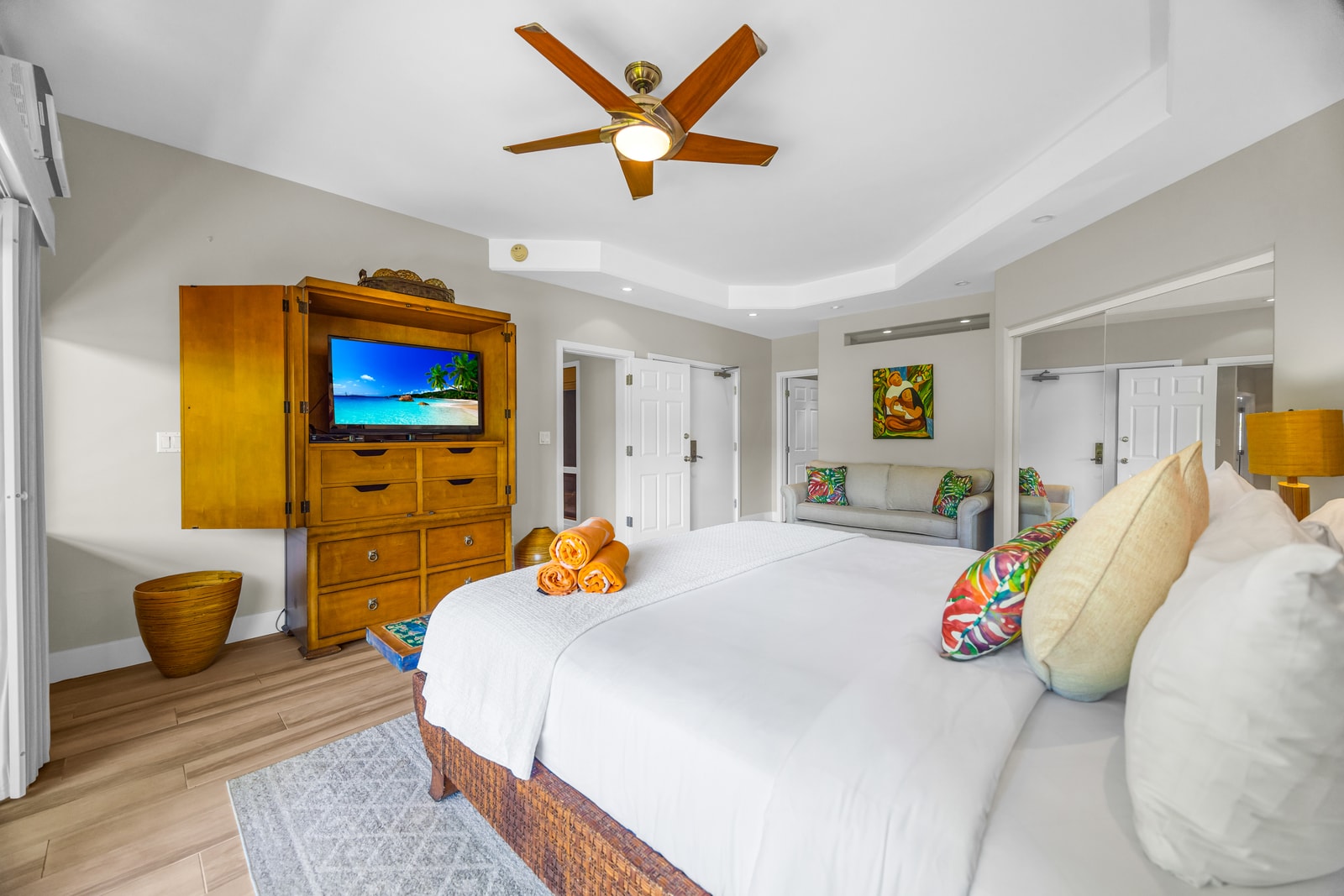 Retreat to a serene primary bedroom with island charm