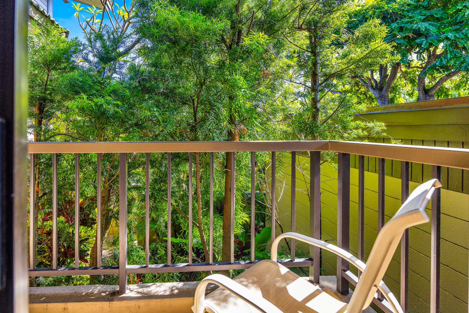 Step outside from the bedroom onto your private balcony for fresh air and tropical green views.