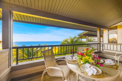 Catch golden hour from your shaded balcony with peekaboo ocean views and tropical surroundings.