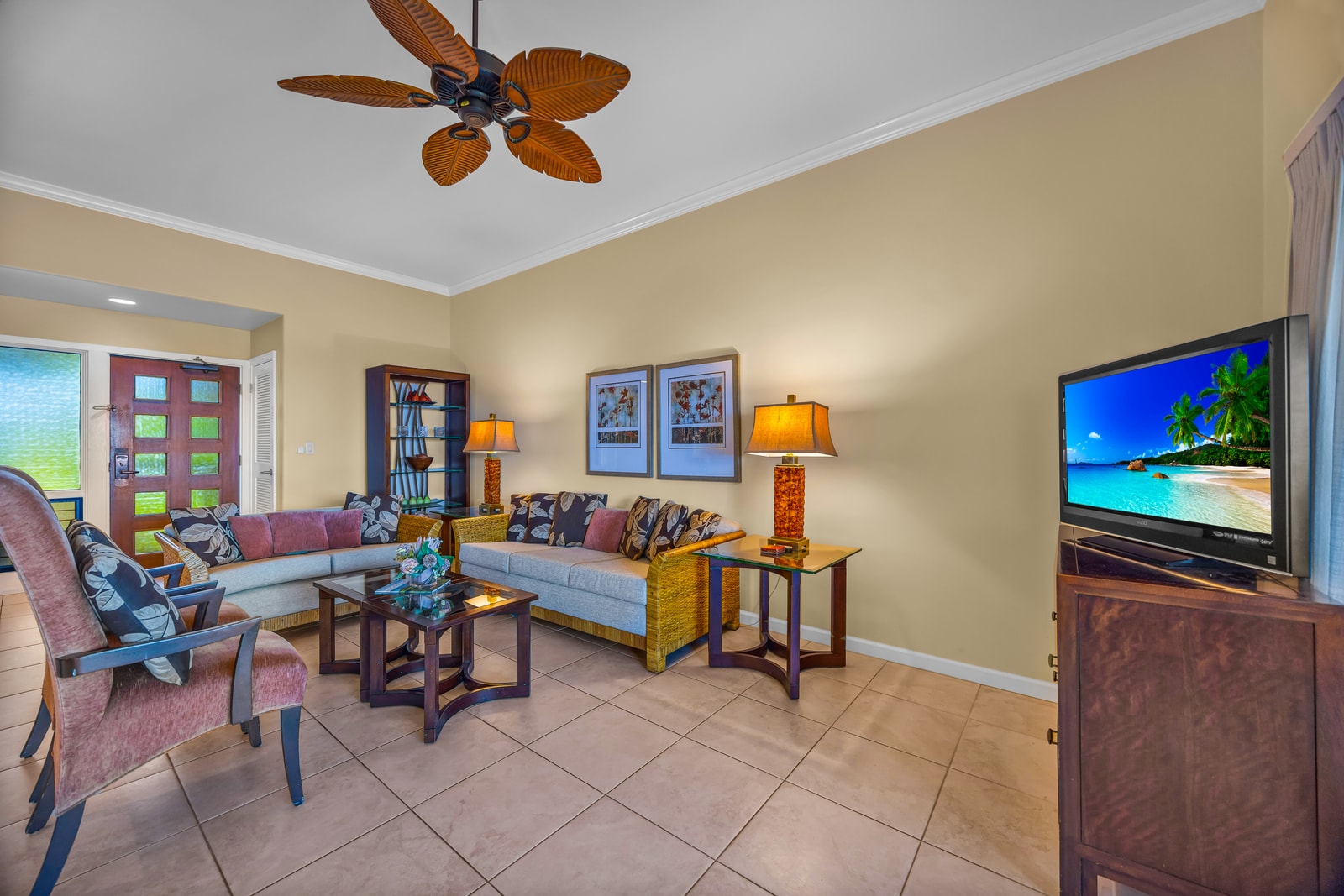 Ocean glimpses and balcony access make this living space a perfect spot to gather and unwind.