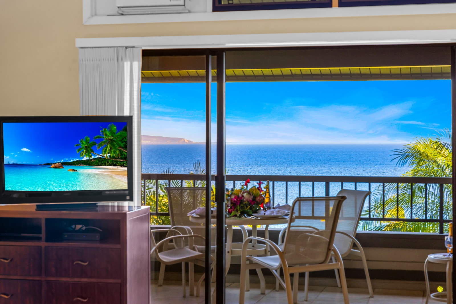 Floor-to-ceiling glass brings the outdoors in, with balcony seating for morning coffee or ocean peeks.