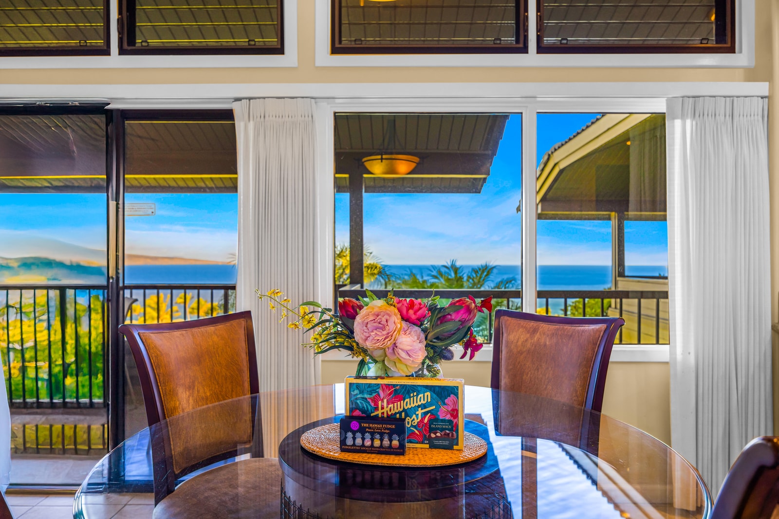 Dine indoors with partial ocean views and direct access to the balcony for open-air options.