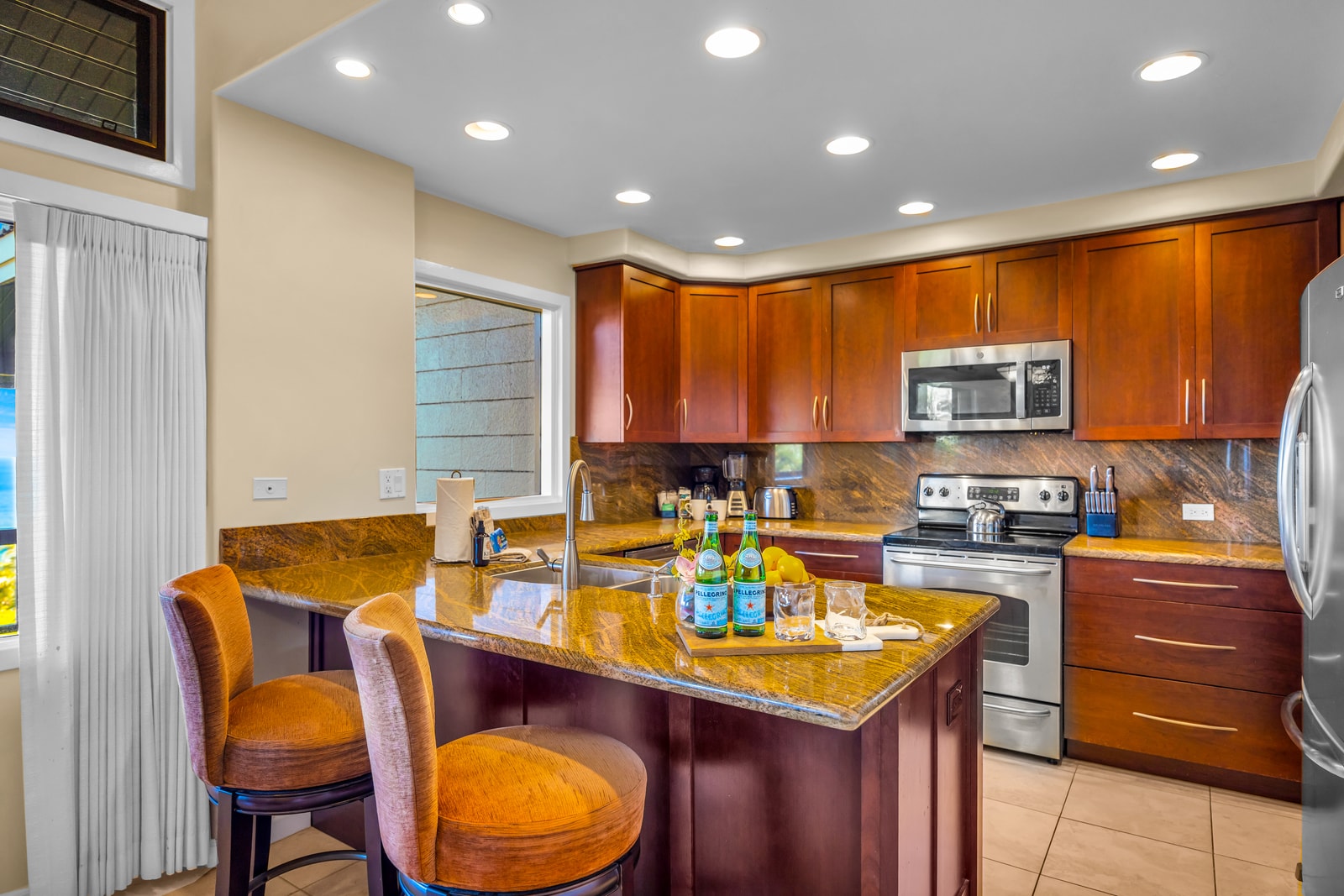 Granite countertops, stainless appliances, and bar seating make this kitchen functional and guest-ready.