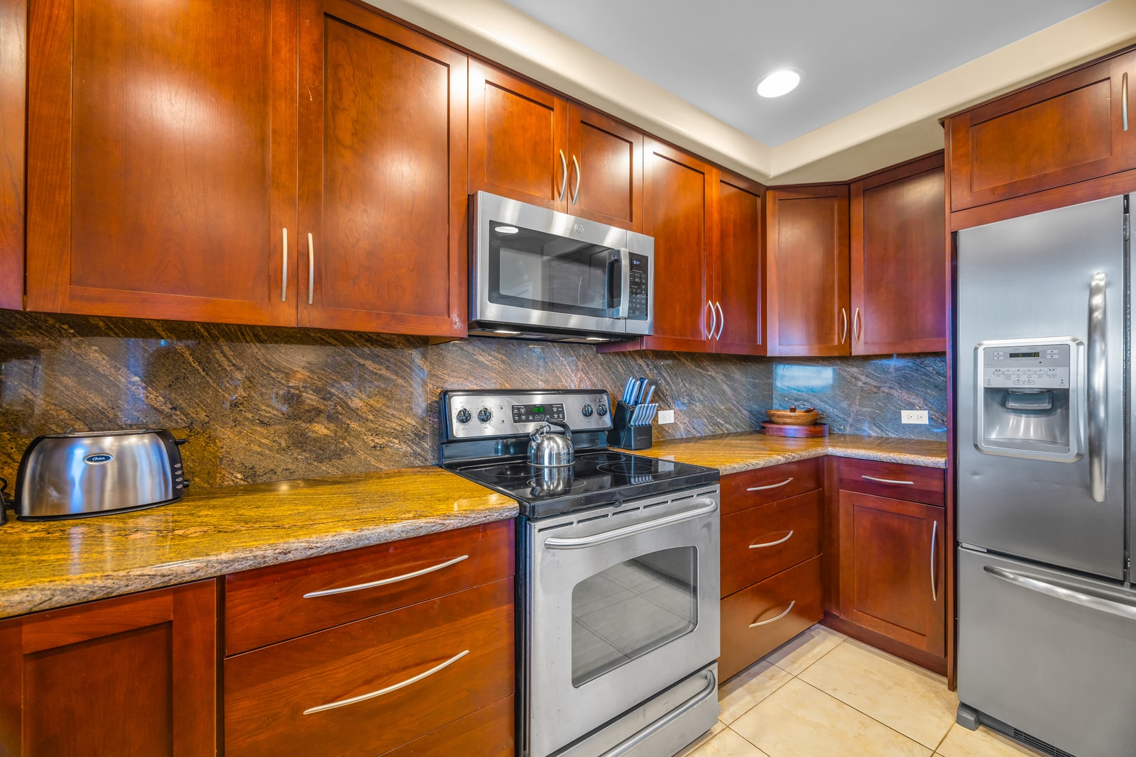 Full-size stainless appliances and rich cabinetry make this kitchen both stylish and functional.