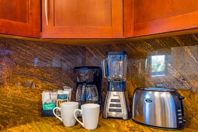 Wake up to fresh coffee with everything you need, from mugs to grinder, right on the granite counter.