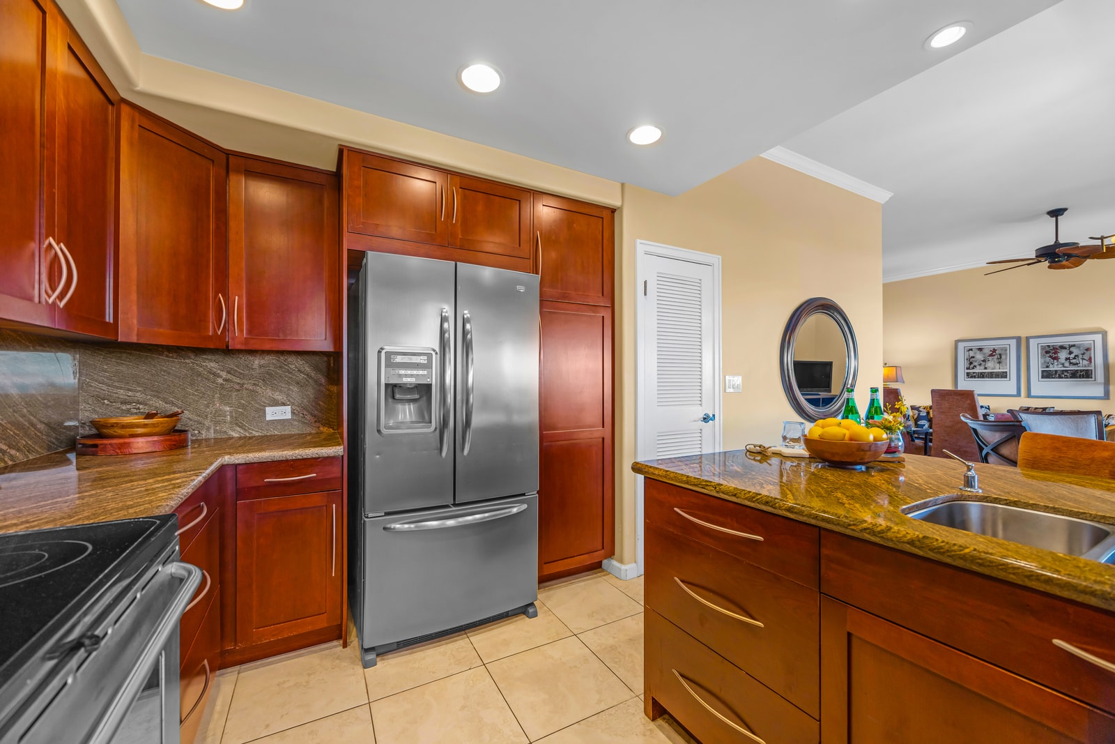 This kitchen blends rich finishes with function, including an island and easy access to the dining area.