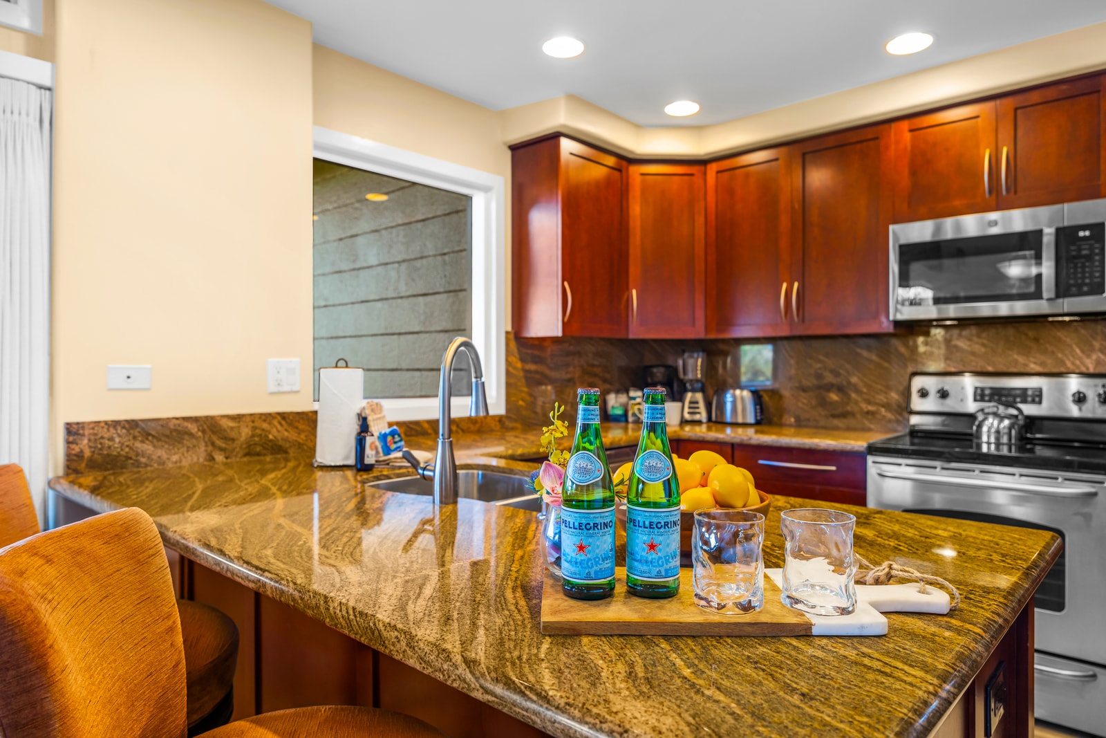 Serve drinks or quick bites at the granite bar, with room for everyone to gather nearby.