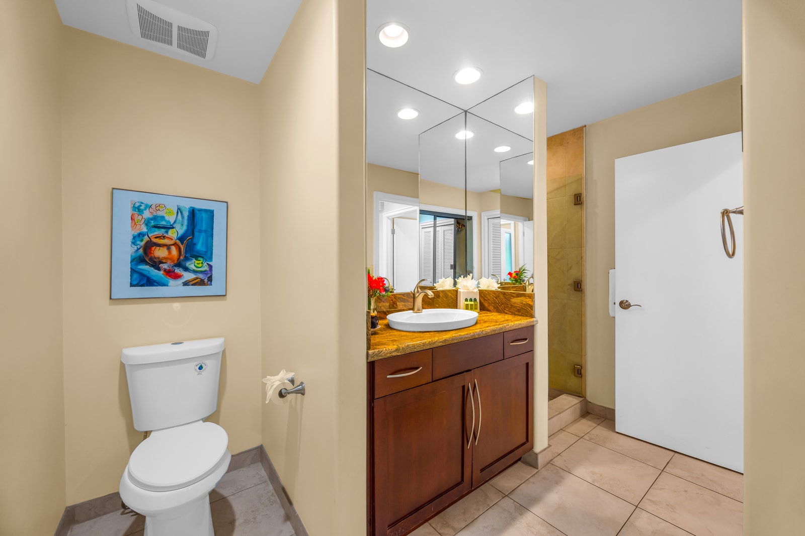 Your guest bath includes a full shower, toilet, and granite sink with modern fixtures.