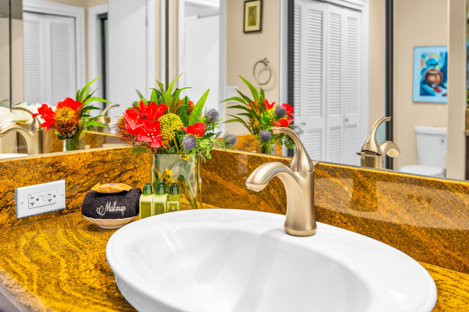 Granite counters and bright finishes make the guest bath both practical and welcoming.