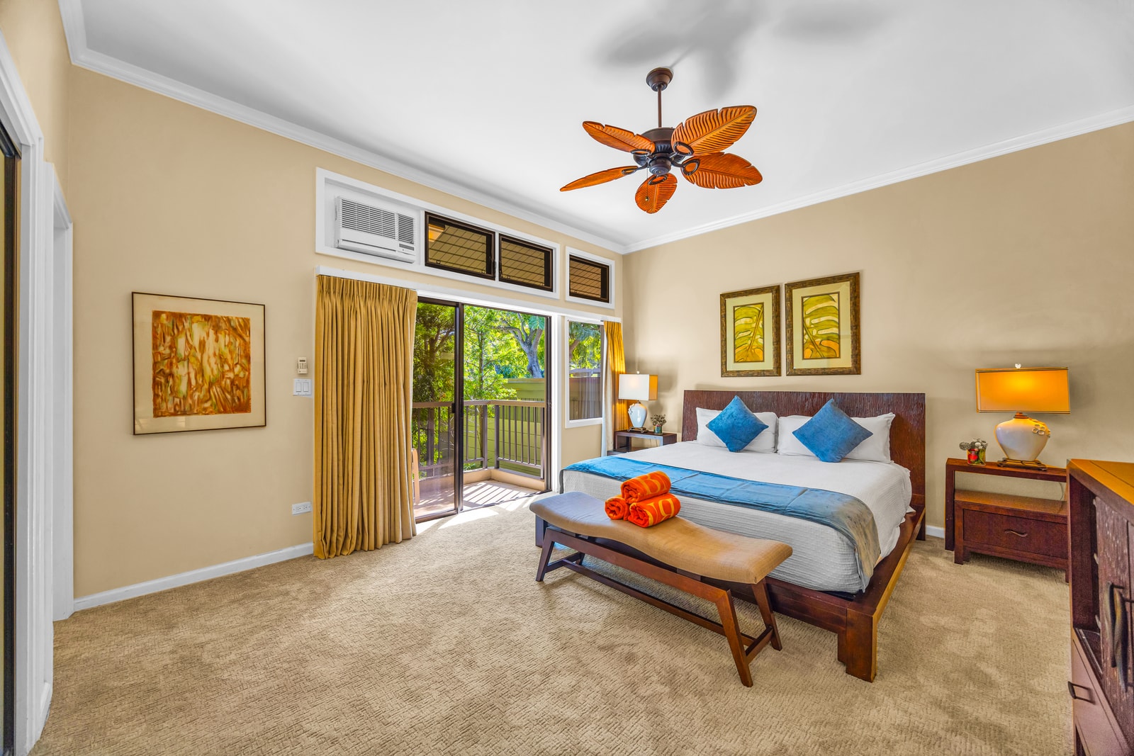 Your primary suite features a King bed, ceiling fan, and direct balcony access for morning breezes.