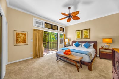 Your primary suite features a King bed, ceiling fan, and direct balcony access for morning breezes.