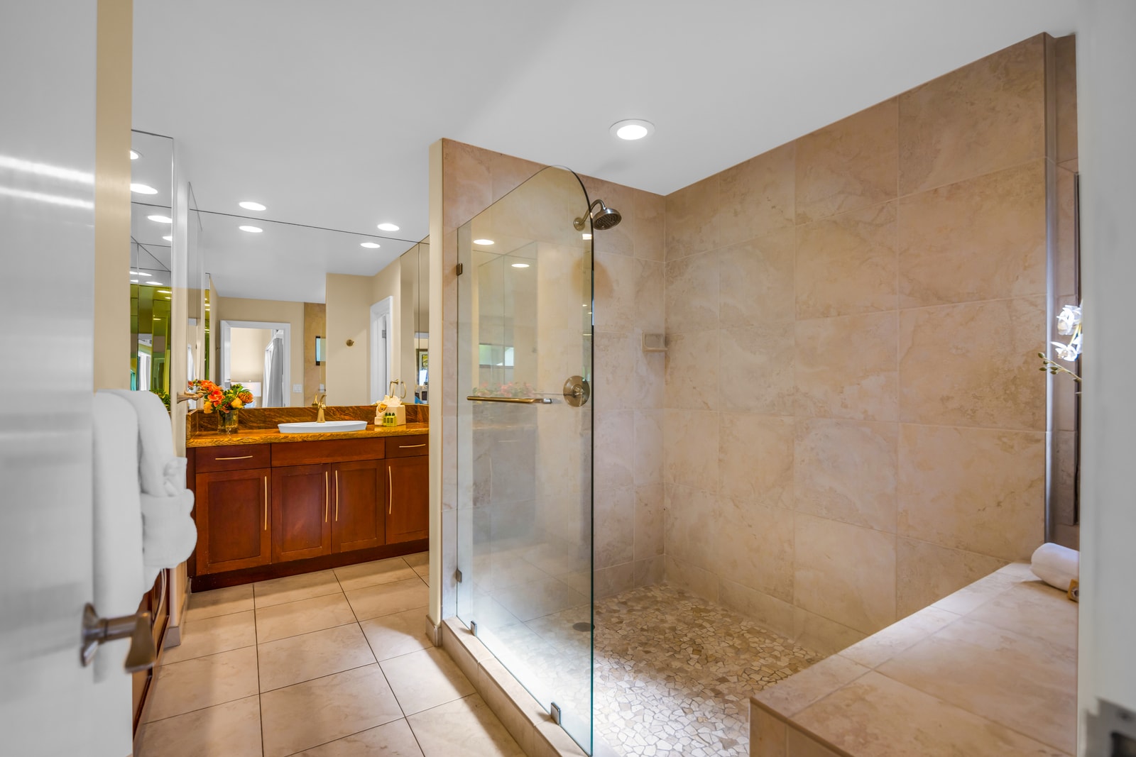This bright, spacious primary bath includes a full-size shower, granite counters, and thoughtful touches.