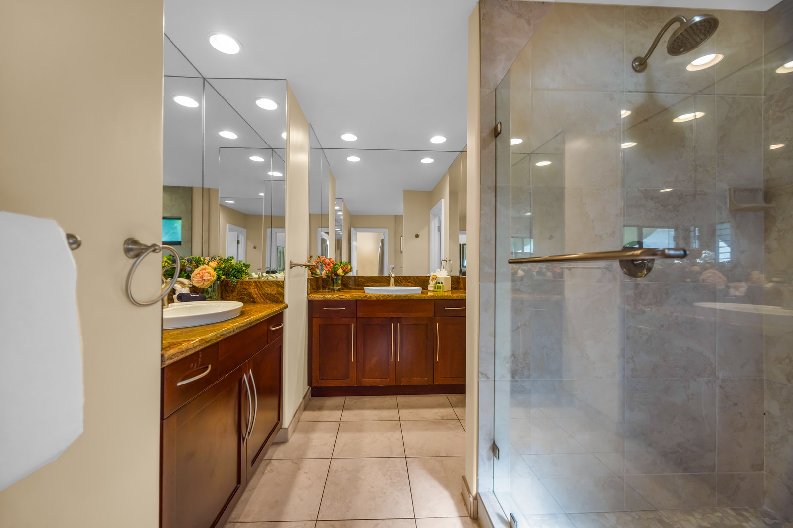 Refresh after the beach in the walk-in shower with tile surround and built-in shelving.
