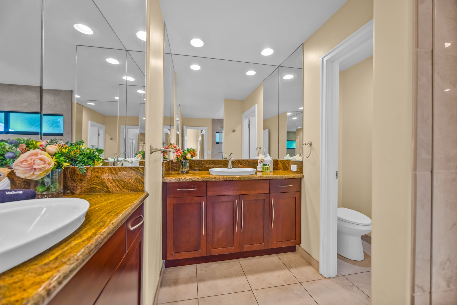 A glass walk-in shower and granite vanity add hotel-style comfort to your private bath.