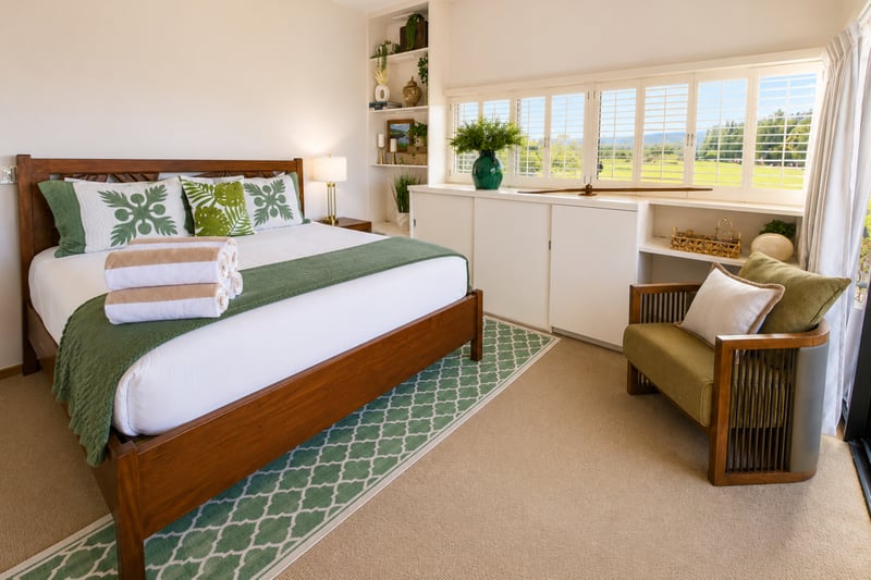 Restful king bedroom with Hawaiian quilts and plush towels