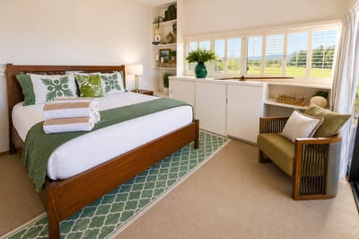 Restful king bedroom with Hawaiian quilts and plush towels