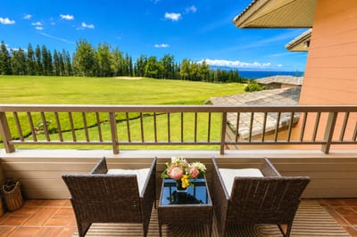Private lanai framing sweeping fairway and Pacific Ocean views