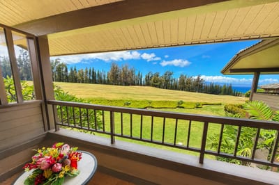 Shaded lanai with fairway, treeline and ocean beyond