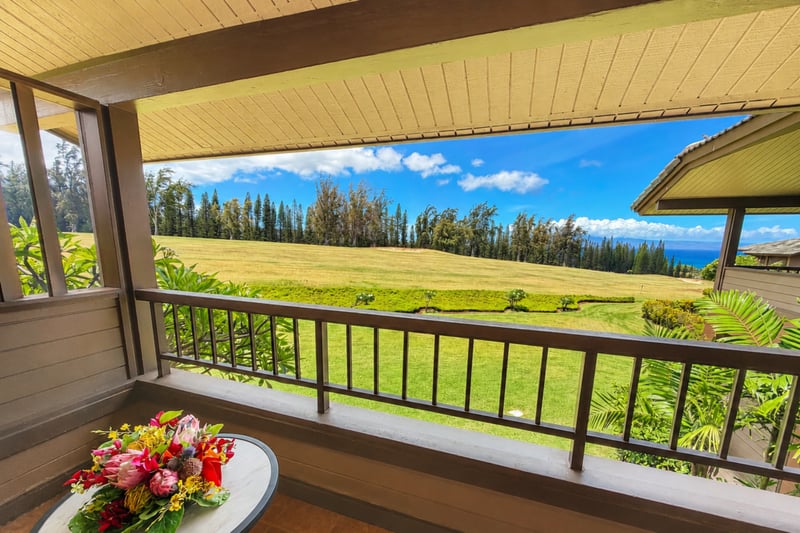 Shaded lanai with fairway, treeline and ocean beyond