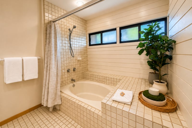 Master bath soaking tub and tiled shower with plush towels