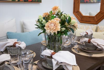 Breezy, beachy, and full of heart—dine beside vintage artwork, woven chairs, and the sea’s gentle lullaby KRV-2823