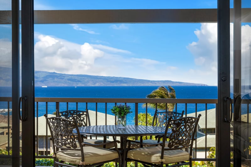 Elegant lanai dining with captivating island and ocean horizon views.