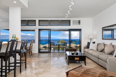 Elegant open-concept living with stunning ocean views and balcony seating.