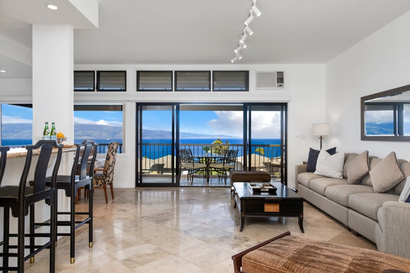 Elegant open-concept living with stunning ocean views and balcony seating.