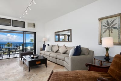 Spacious ocean-view living room with tropical elegance and plush comfort.