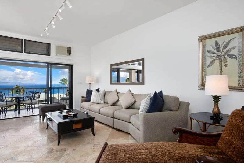 Spacious ocean-view living room with tropical elegance and plush comfort.