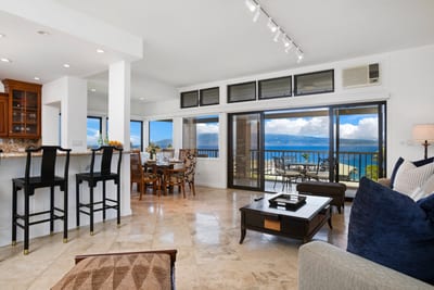 Bright oceanfront dining and living space with seamless indoor-outdoor flow.