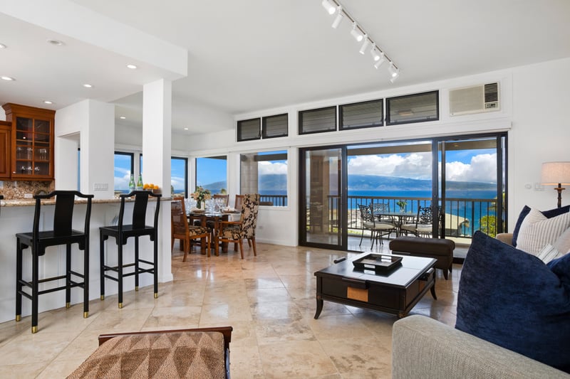 Bright oceanfront dining and living space with seamless indoor-outdoor flow.