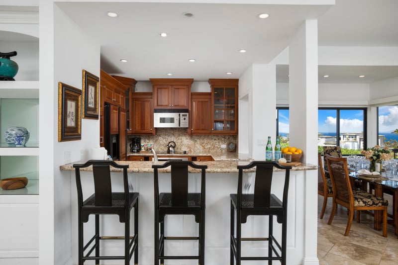Inviting kitchen bar opens to ocean-view dining experience nearby.