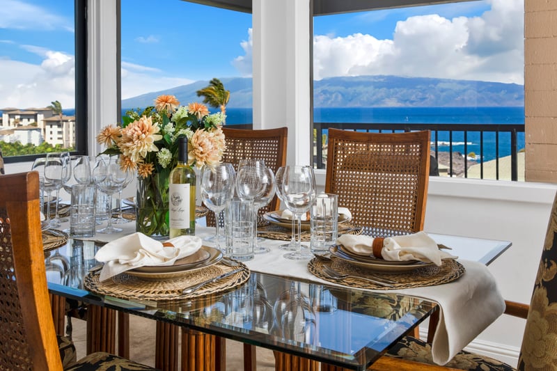 Elegant ocean-view dining with tropical charm and luxury glass setting.