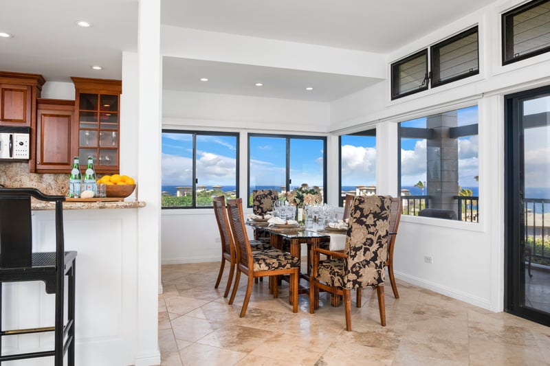 Spacious dining retreat with ocean views and elegant tropical decor.