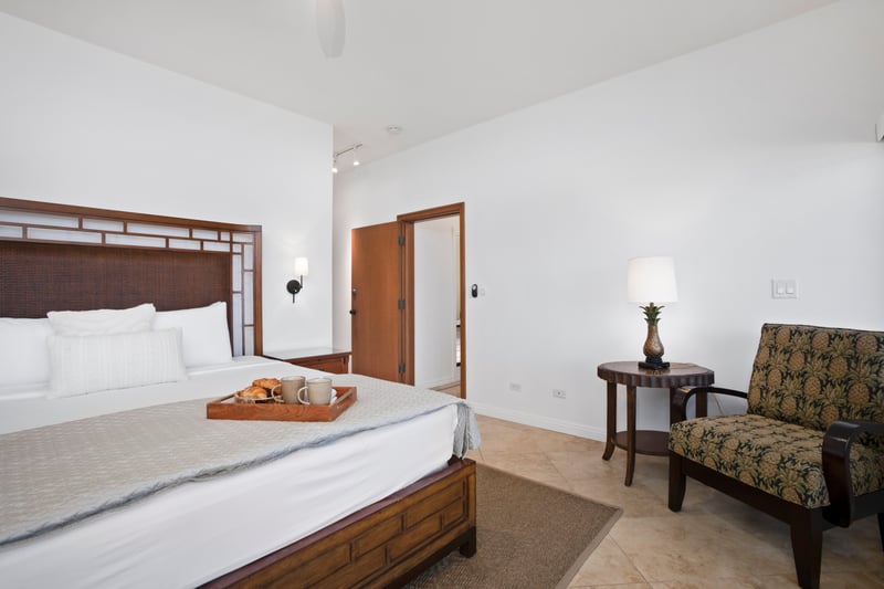 Peaceful bedroom escape with tropical accents and warm wood finishes.