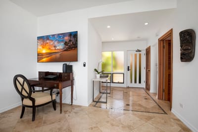 Tropical elegance meets modern workspace in this serene entry nook.
