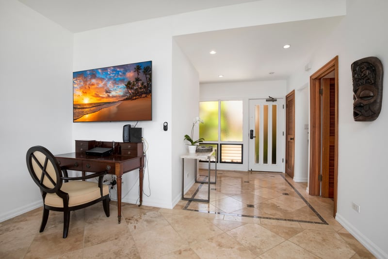 Tropical elegance meets modern workspace in this serene entry nook.