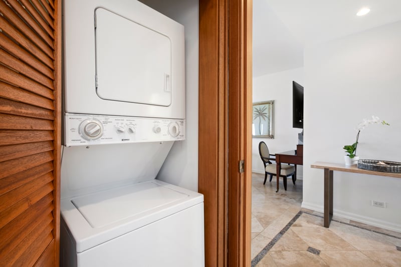 A clean design and warm lighting make everyday tasks like laundry feel like part of the vacation experience