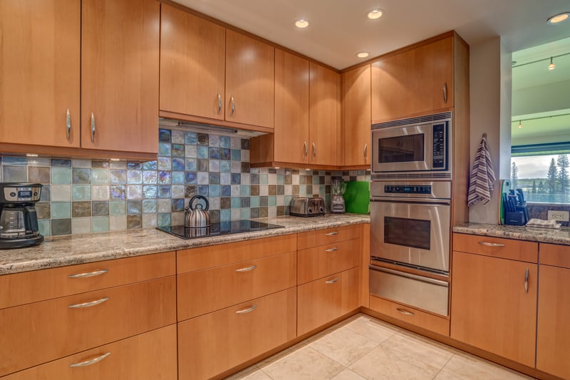 Channel your inner chef in this sparkling wood-toned kitchen with mosaic tile magic and glimmering granite KRV-722