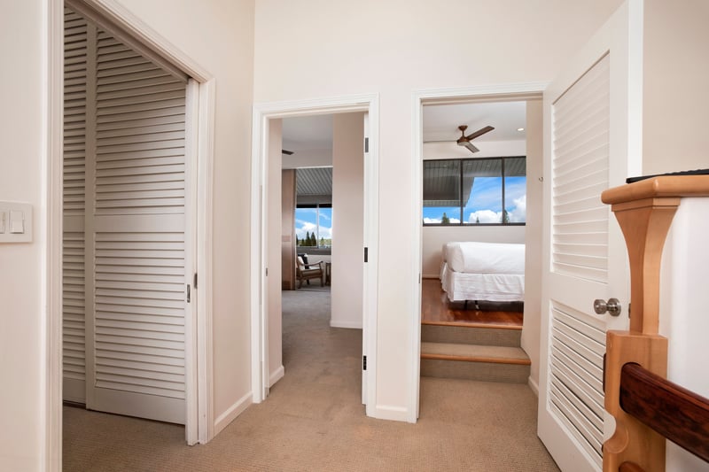 Step into this bright and inviting hallway that seamlessly connects two serene bedrooms, each offering lush views and cozy charm KRV-722