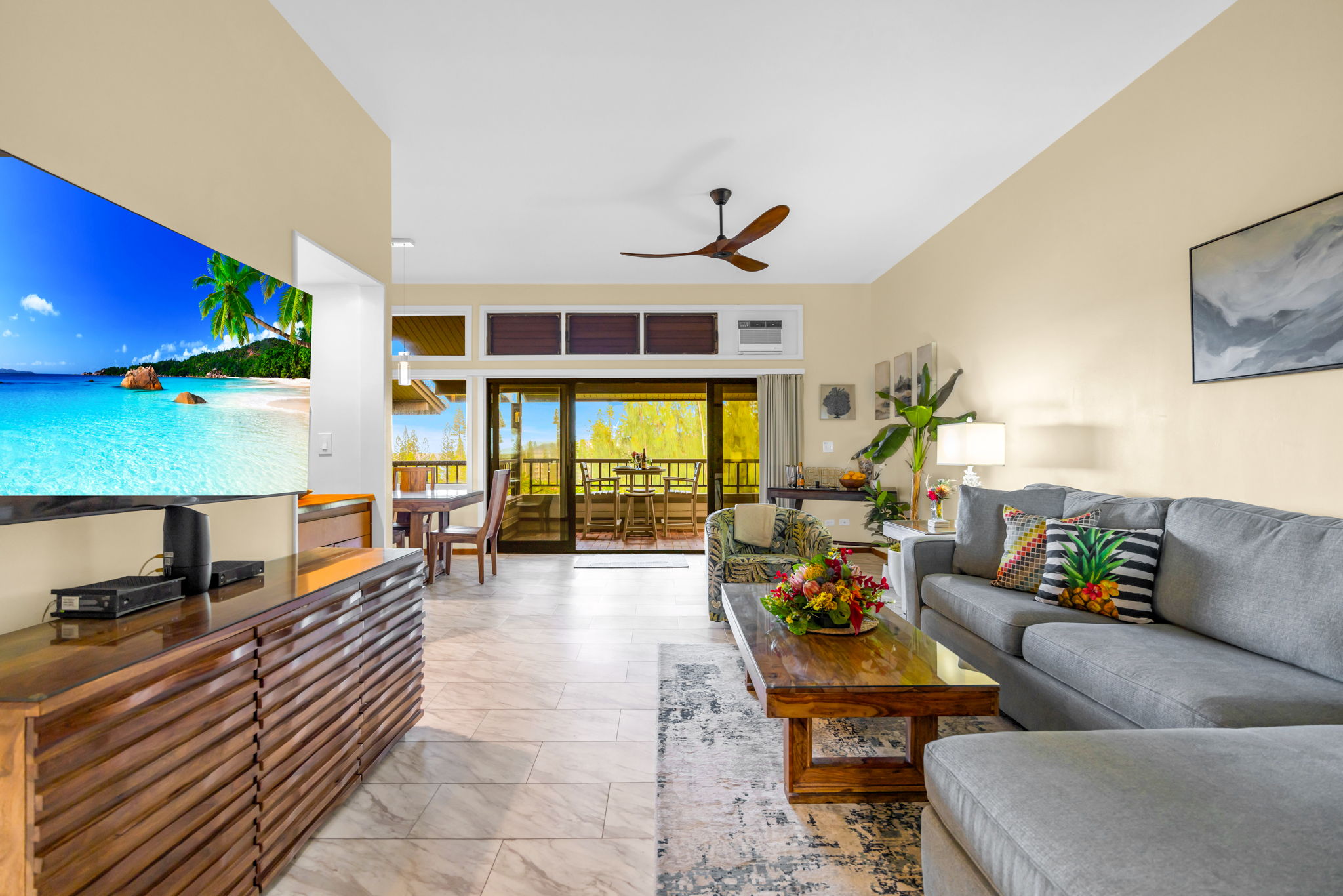 Bright, welcoming living space with plush seating and access to the lanai.
