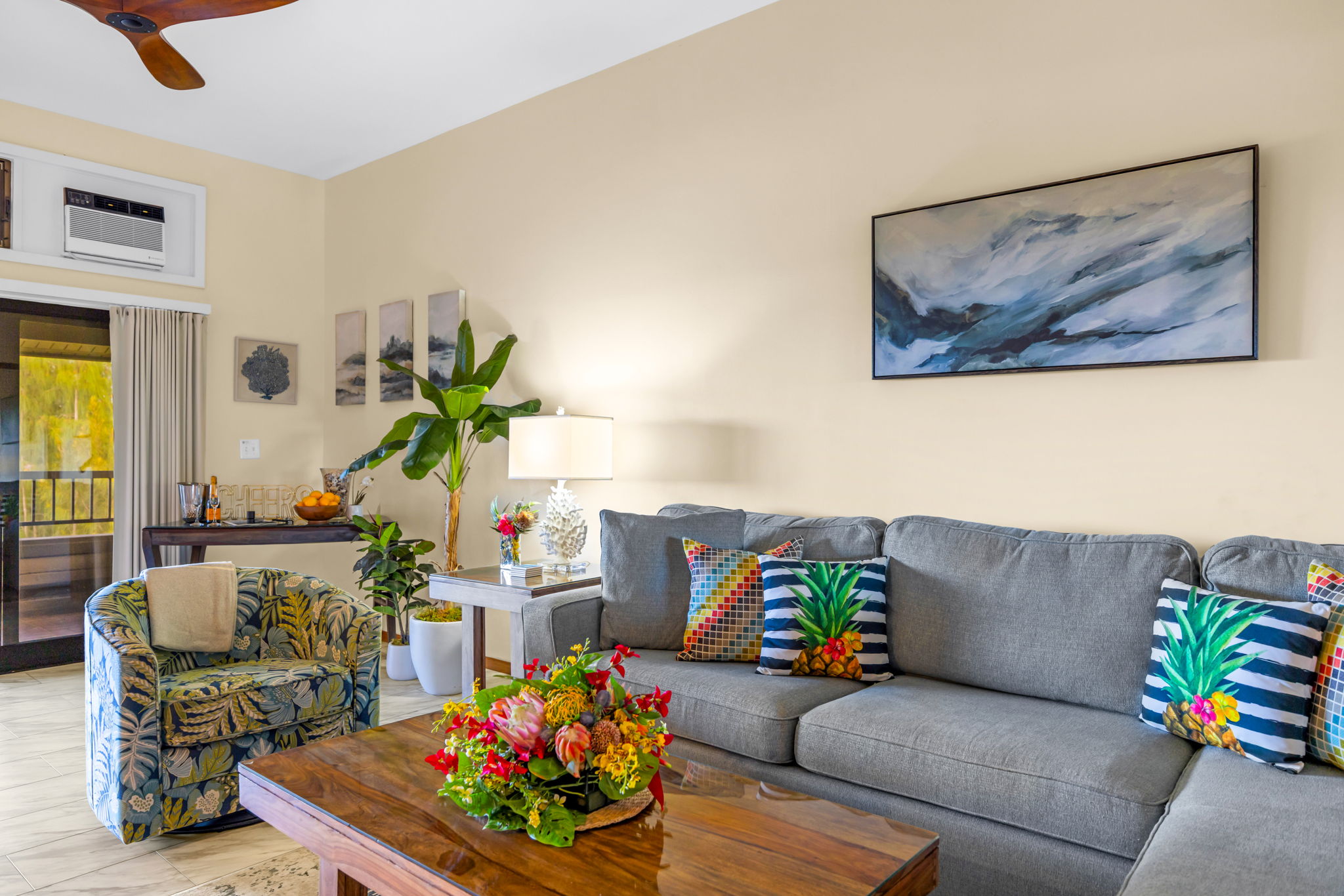 Relax in your coastal-inspired living area with ceiling fan and large Smart TV.