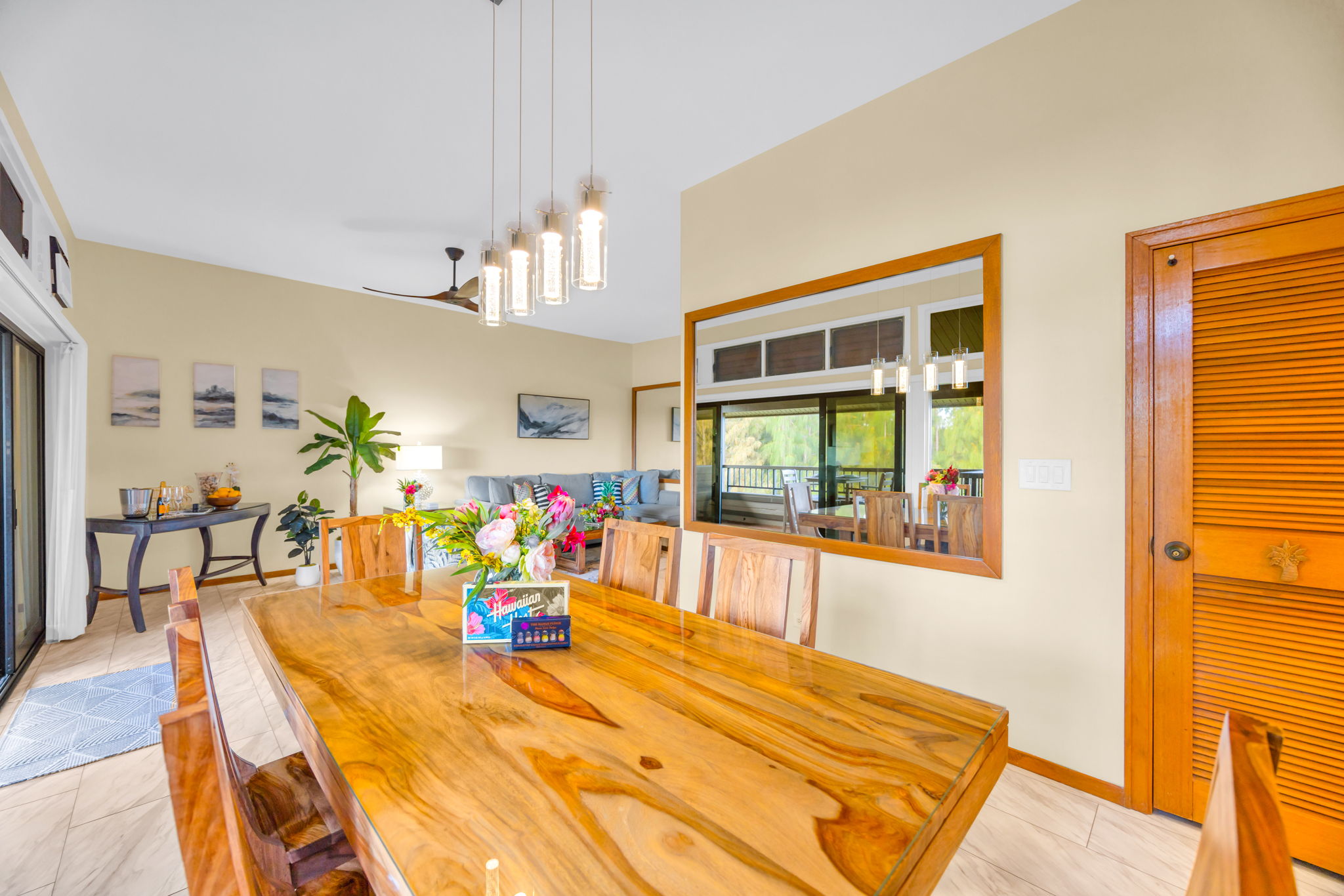 Island-style dining table seats four with warm wood finishes and natural light.