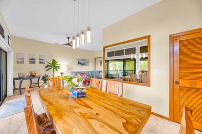 Island-style dining table seats four with warm wood finishes and natural light.