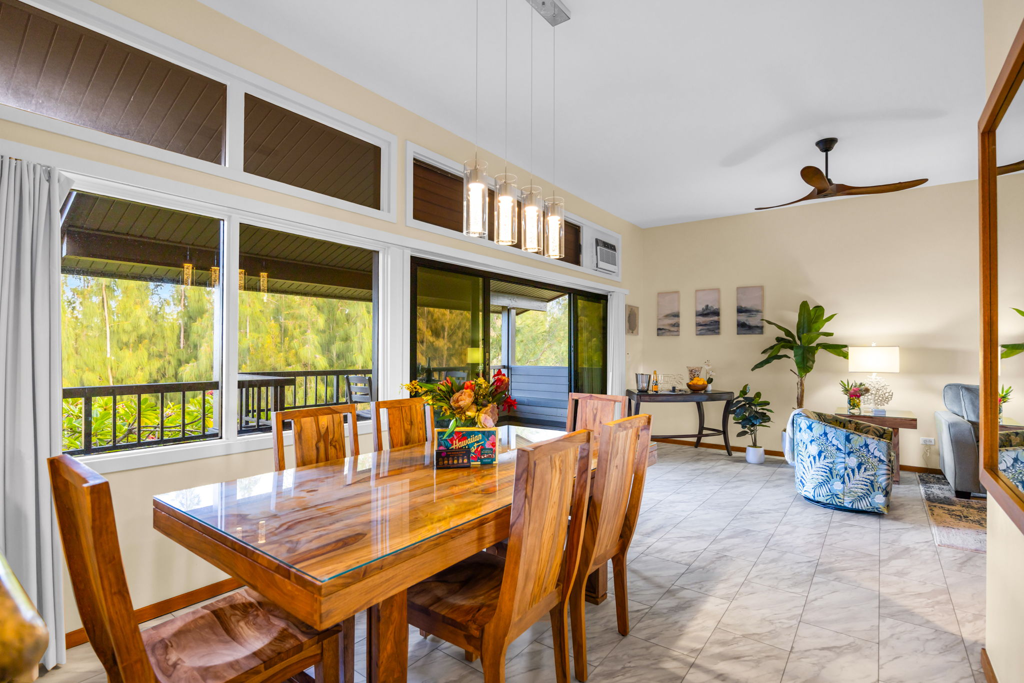 Bright, open dining area with greenery and treetop views.